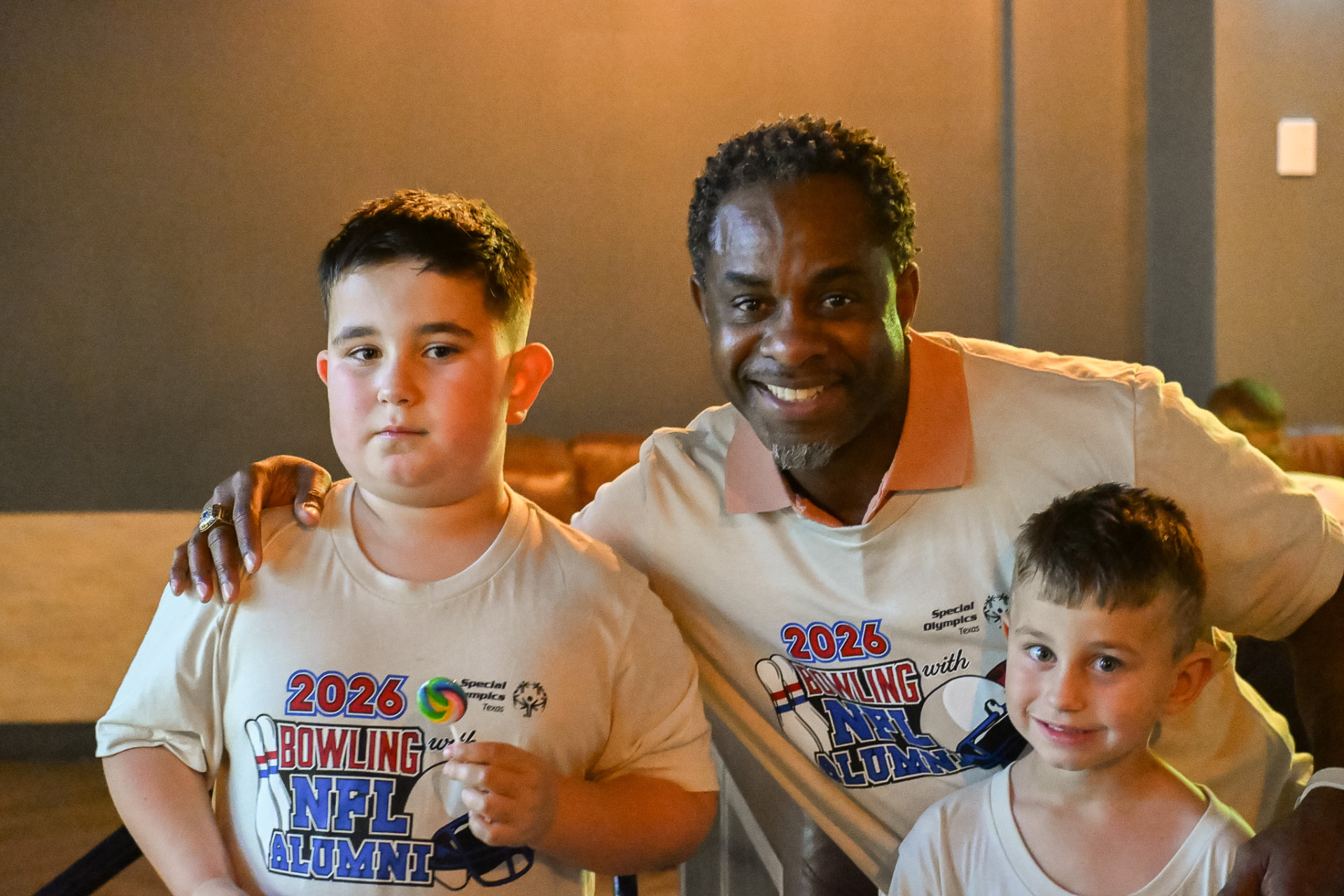 Rodrick Walker with young children at a community event